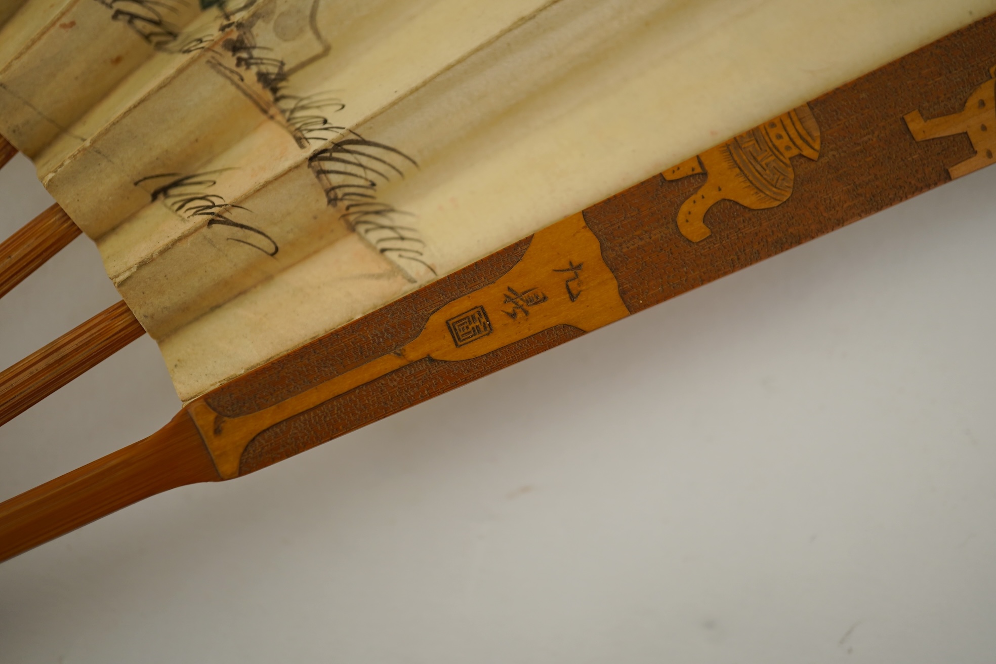 Two Chinese inscribed paper leaf fans, late 19th century
